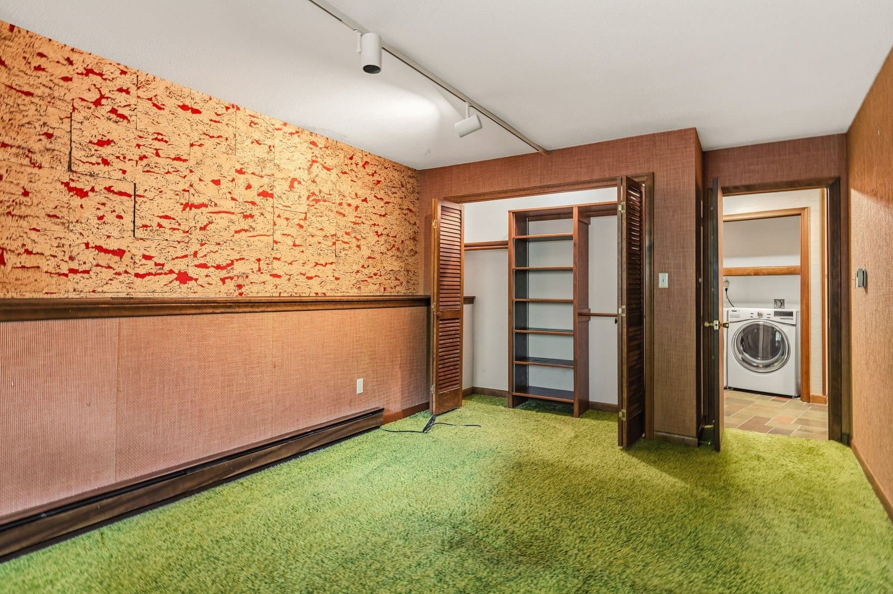 The lower-level bedroom's closets, with the laundry through the door